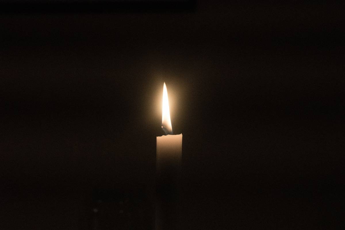 Elegant candle with rings for gift on wooden mantel with soft lighting