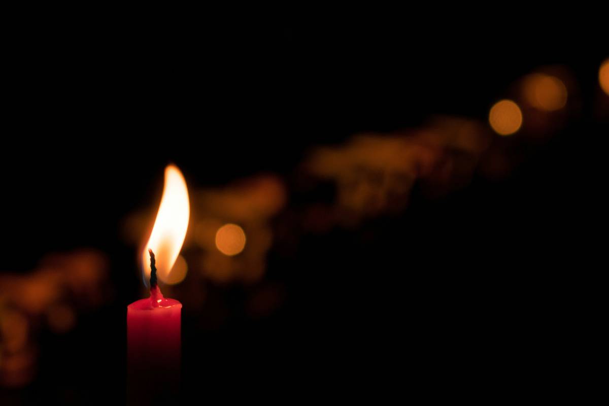 Close-up of handmade candle with rings for gift featuring dried orange slices and cinnamon sticks