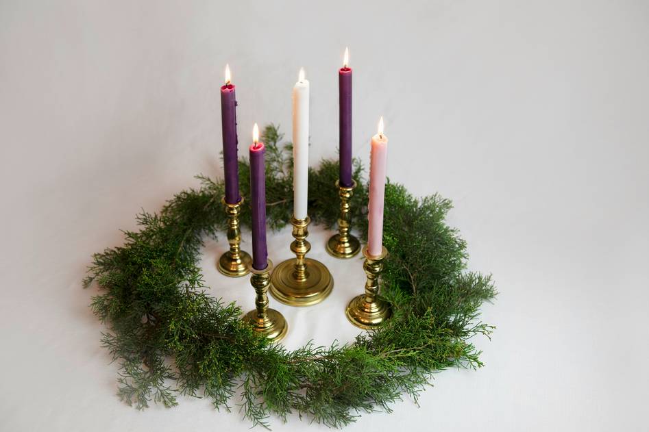 Cozy living room vignette featuring layered candle rings on a reclaimed wood tray