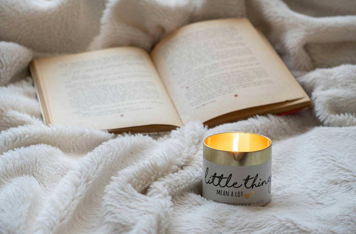 Close-up of handmade rings in a candle with seasonal foliage and berries